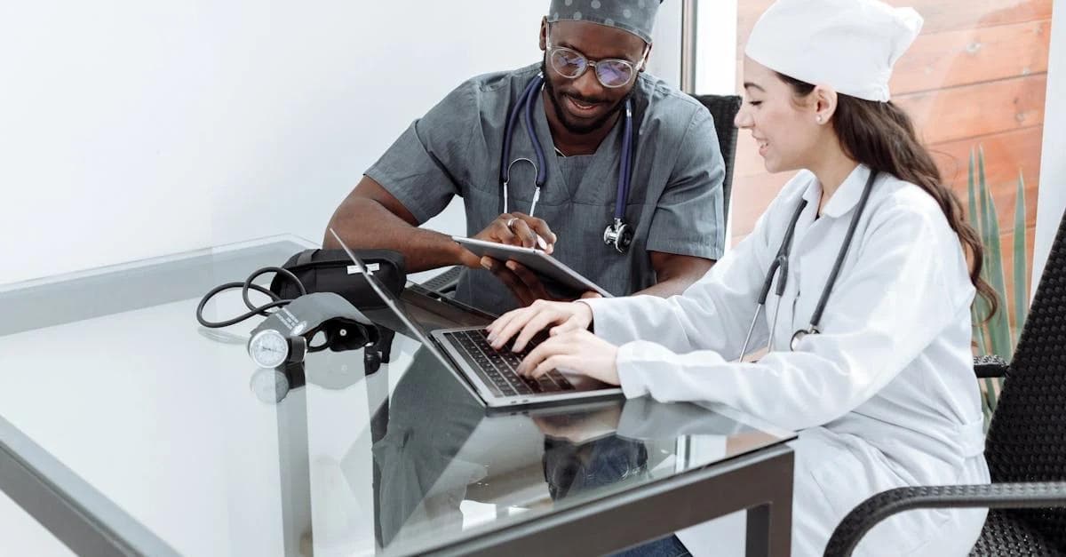 Healthcare professionals collaborate with digital tools, showcasing modern medical teamwork and patient care efficiency.