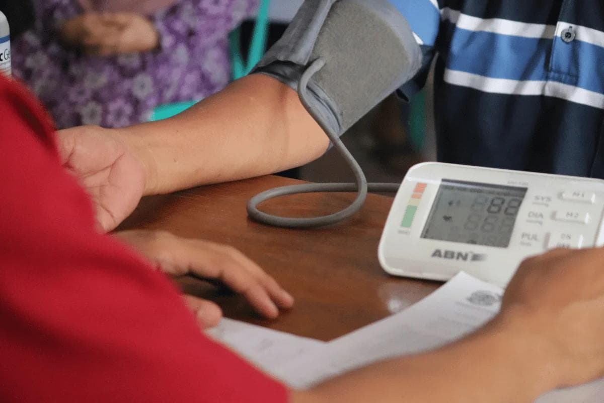 Blood pressure being checked using a digital monitor.